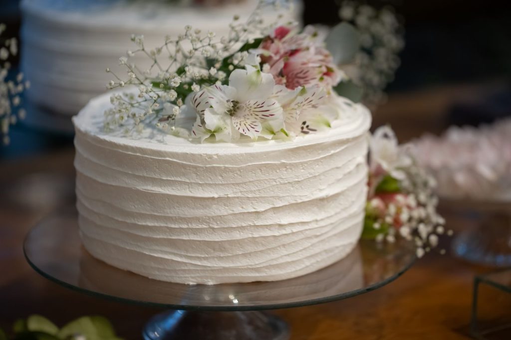 Beautiful white cake topped with flowers perfect for weddings and celebrations.