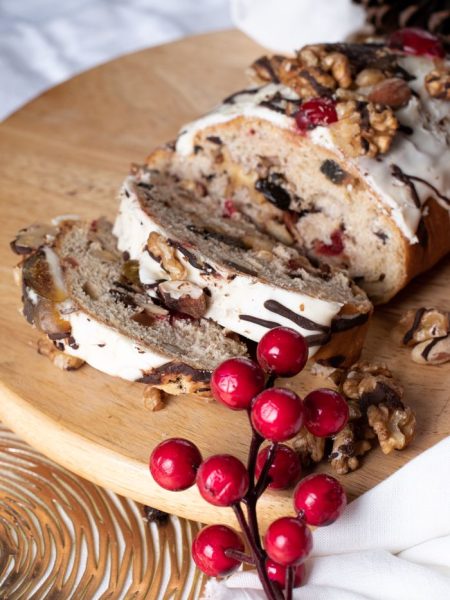 Delicious fruit and nut bread with frosting, perfect for holiday celebrations.