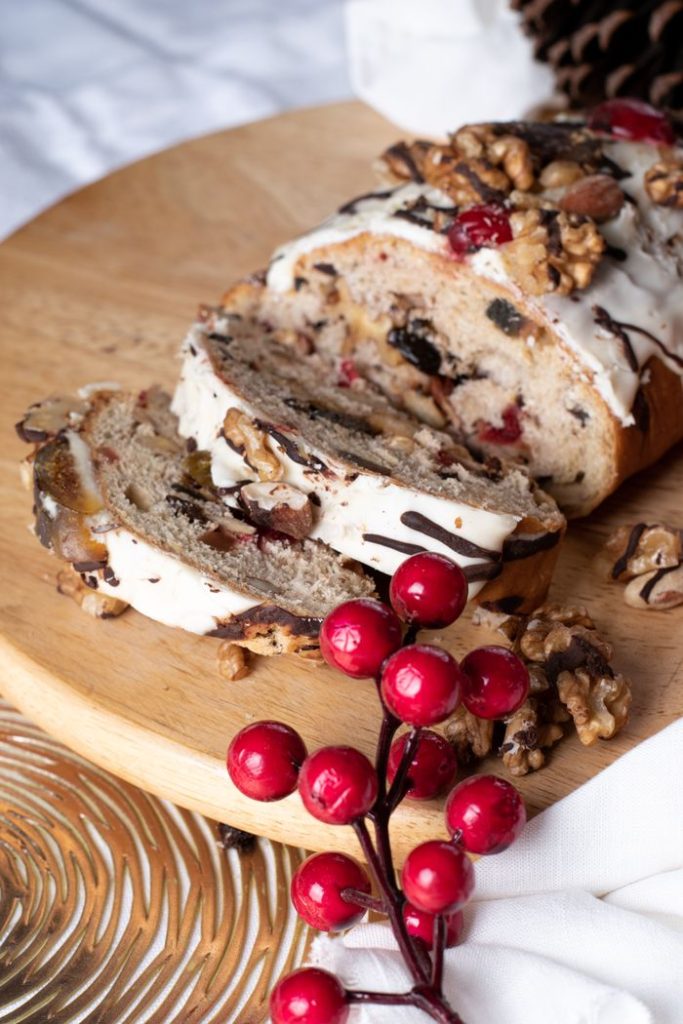 Delicious fruit and nut bread with frosting, perfect for holiday celebrations.