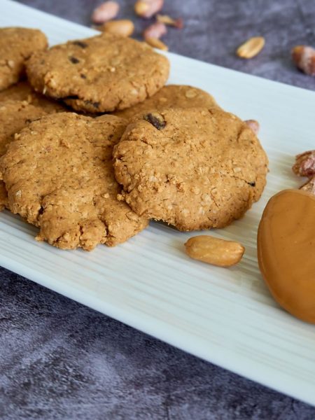 Close-up of tasty peanut butter cookies arranged on a white plate, perfect for food photography.